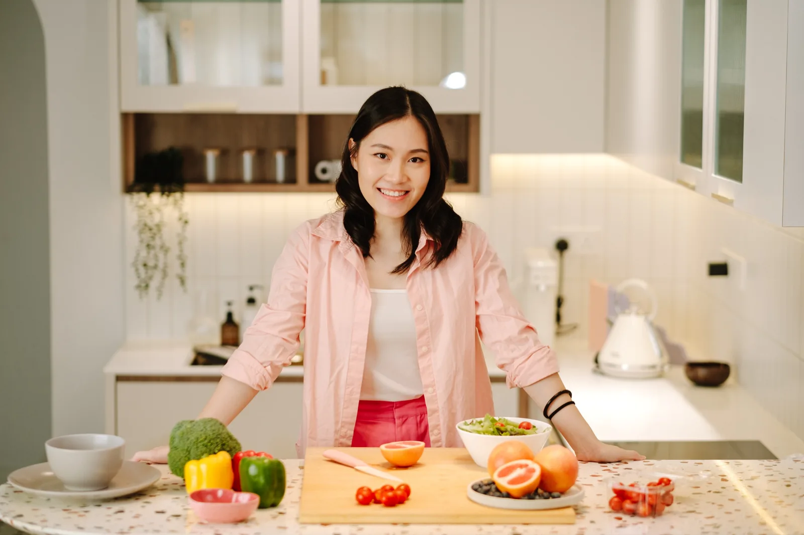 Dietitian Xinthia Chua in a kitchen with fresh produce