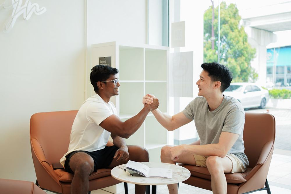 A coach and client shaking hands after a consultation
