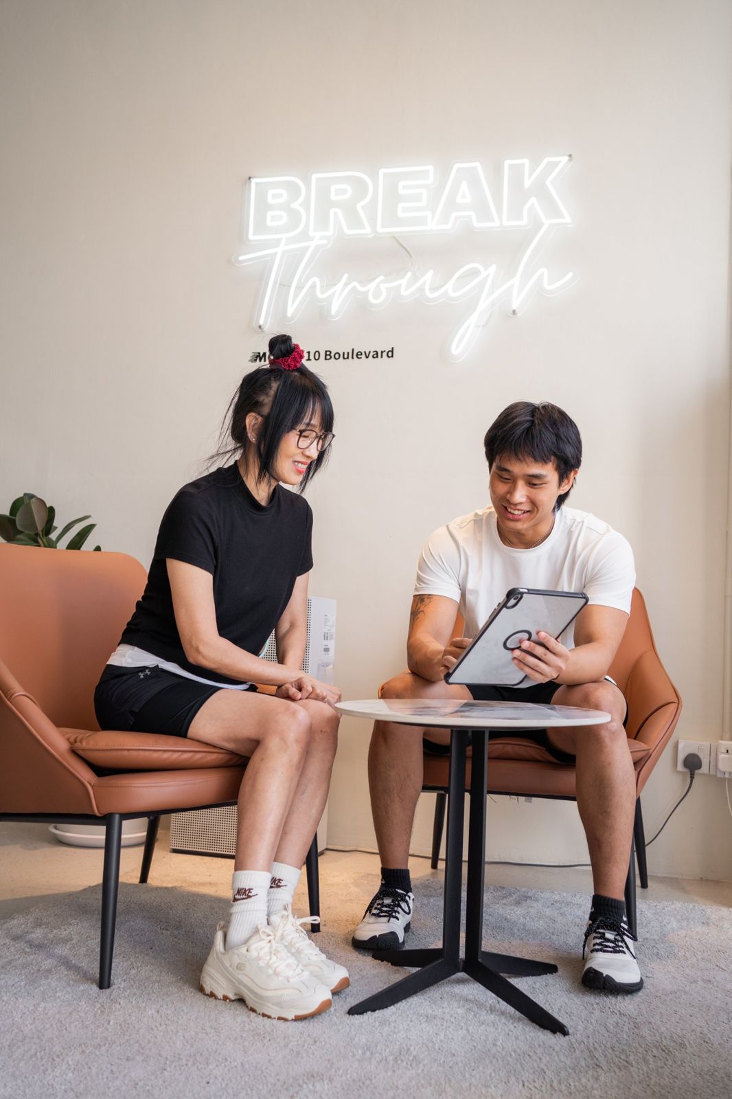 A client and her MOVE coach reviewing her plan together in the studio lounge